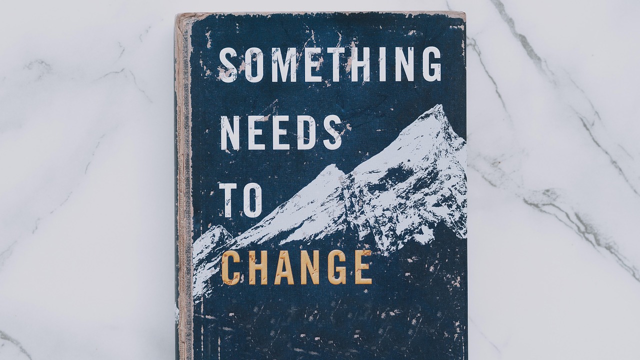 Schild "Something needs to change"